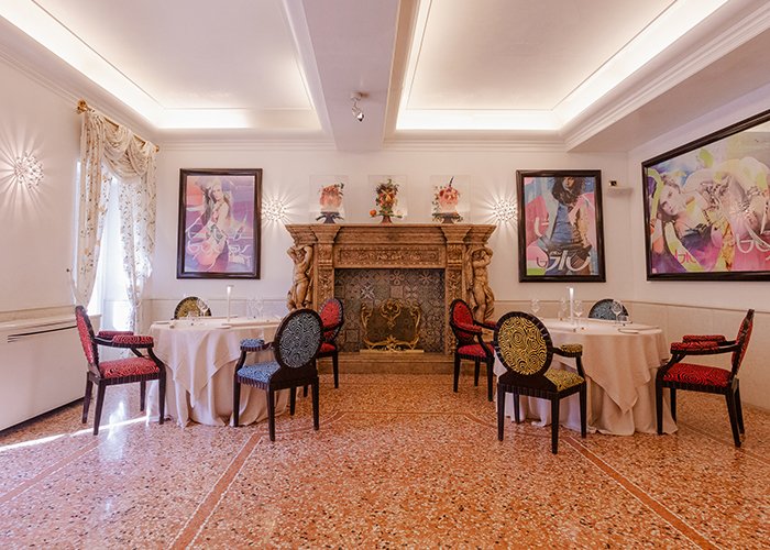 Ambiente elegante con camino decorato e quadri colorati su sfondo bianco